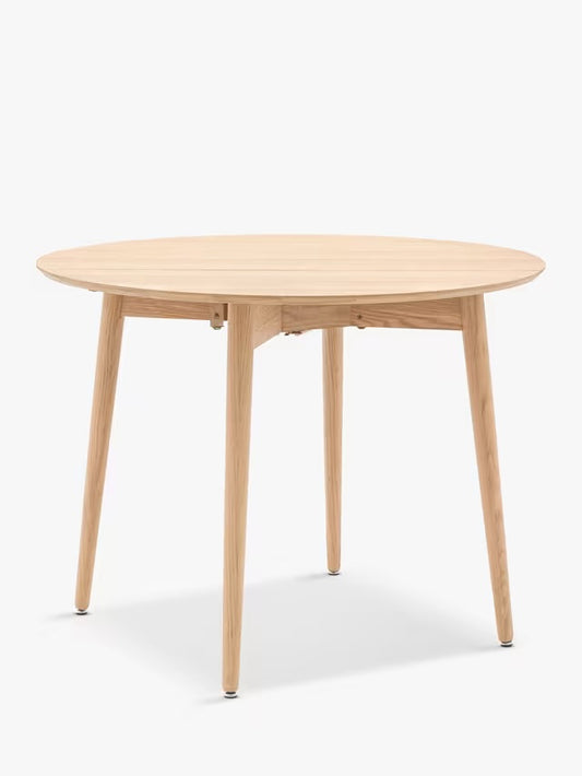 Gallery Direct Lewes folding dining table in natural oak with a round top and shaped wooden underframe