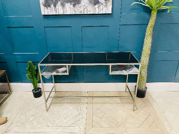 Gallery Direct Rothbury Desk in Silver with clear glass top and open storage shelves"
