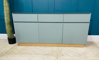Green MADE.com Elsdon large sideboard providing elegant storage for a modern living room