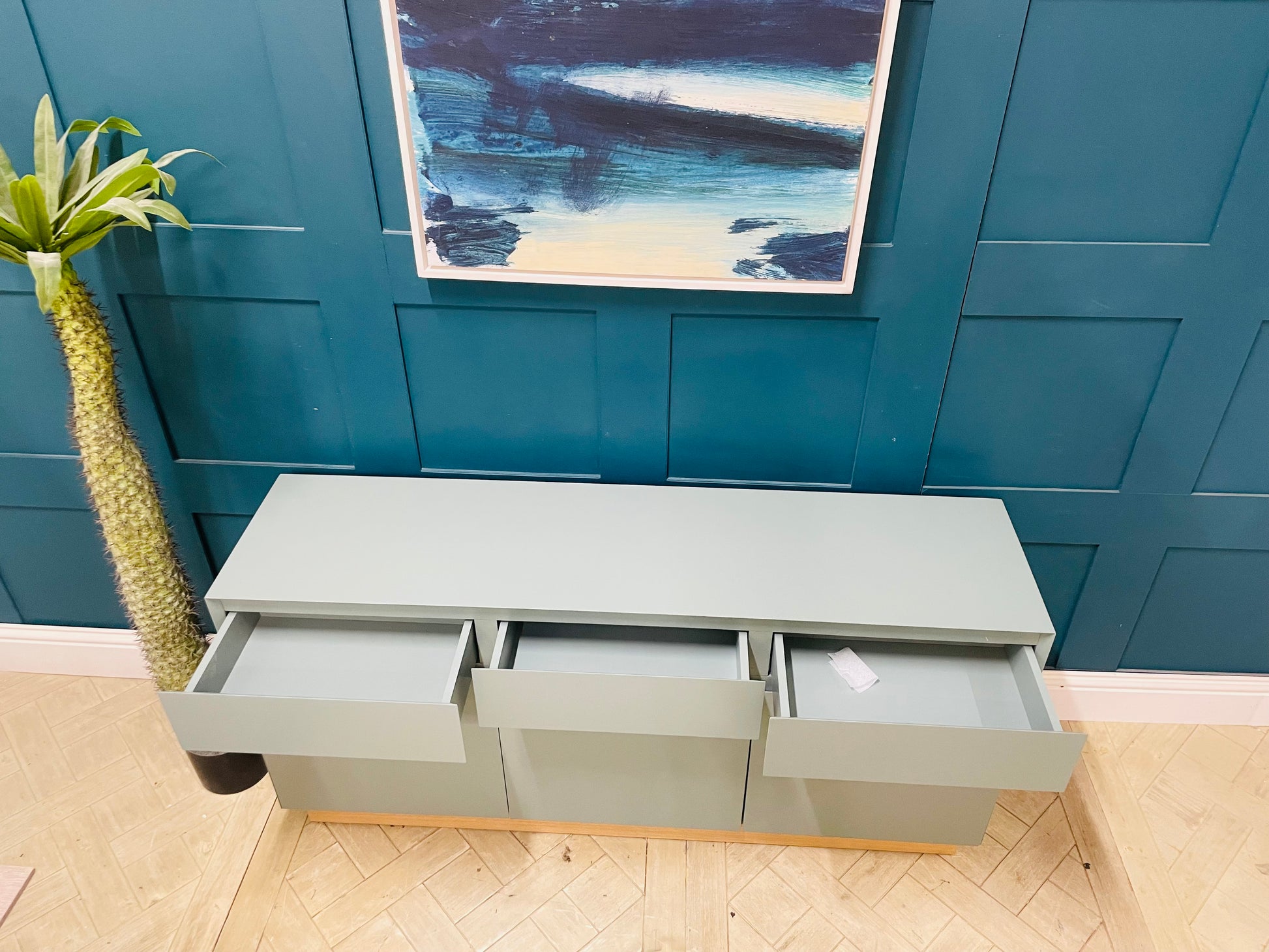 Green MADE.com Elsdon large sideboard providing elegant storage for a modern living room