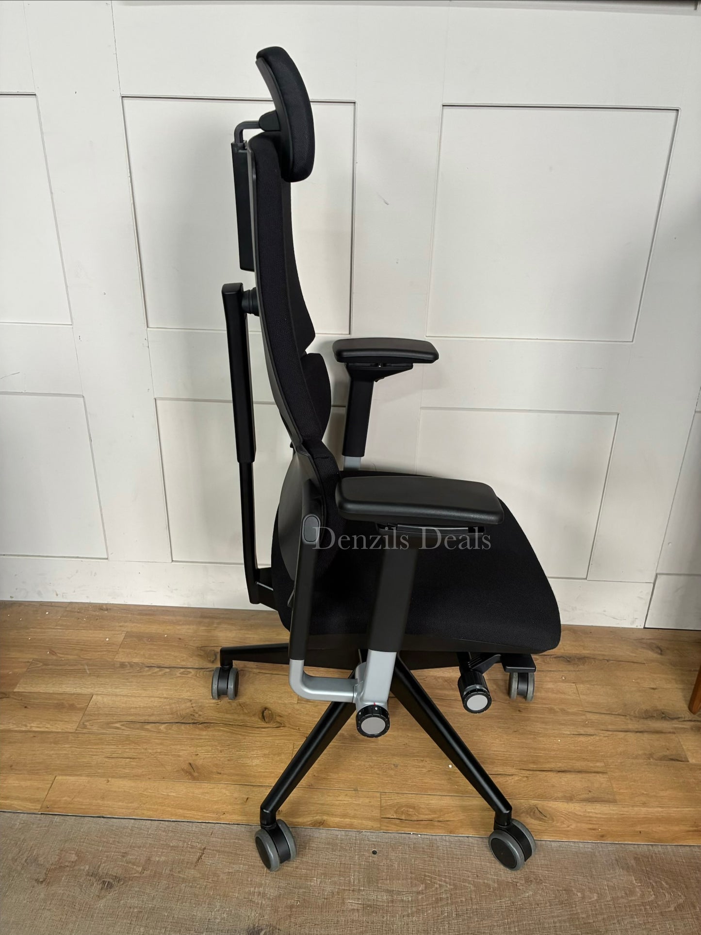 High-back Steelcase Please ergonomic office chair featuring a two-piece flexible backrest, fully adjustable armrests, and a matching fabric headrest.