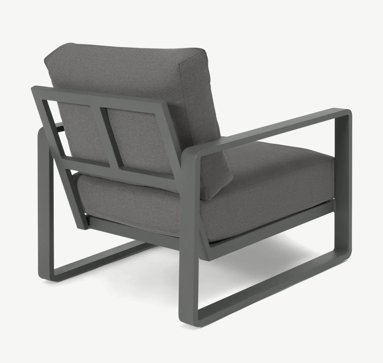 Made.com Topa garden armchair and low coffee table set in solid acacia wood with charcoal grey cushions on a patio.