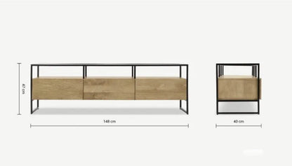 Industrial-style Made.com Kilby Wide TV stand. Features a warm, light mango wood grain base with two roomy storage drawers on clean, black metal legs. The top of the unit is a sleek smoked black glass, designed for placing a media console or television