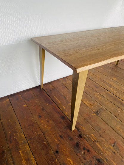 Industrial style Frank Hudson Foundry 180cm dining table with solid oak grain and bronze-finished metal base. Close up view of legs