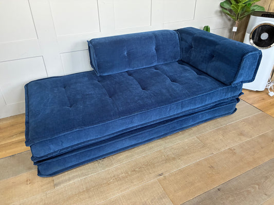 Ink blue Macy double sofa bed from Urban Outfitters with contemporary soft fabric, folded into an upright seated position