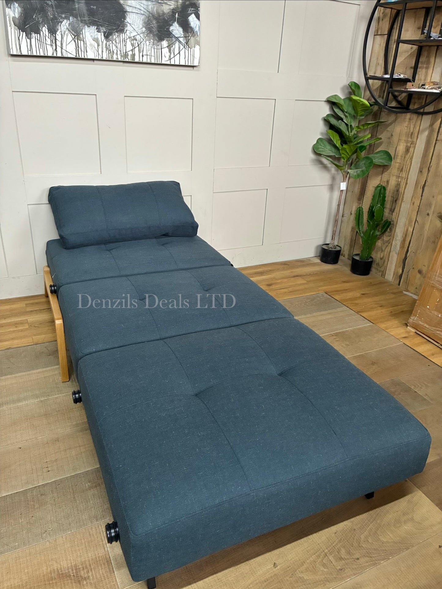 Innovation Living Cubed 90 convertible chair bed in textured Nist Blue fabric. The armchair has a deep seat, a plush button-tufted backrest cushion, and angular chrome legs, showcasing a contemporary Scandinavian design."