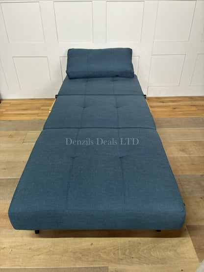 Innovation Living Cubed 90 convertible chair bed in textured Nist Blue fabric. The armchair has a deep seat, a plush button-tufted backrest cushion, and angular chrome legs, showcasing a contemporary Scandinavian design."