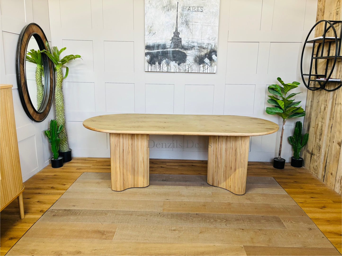 Interior shot of the Anthropologie Scout dining table, crafted from blond ash wood with an organic woodgrain veneer top and whimsical, curved fluted legs