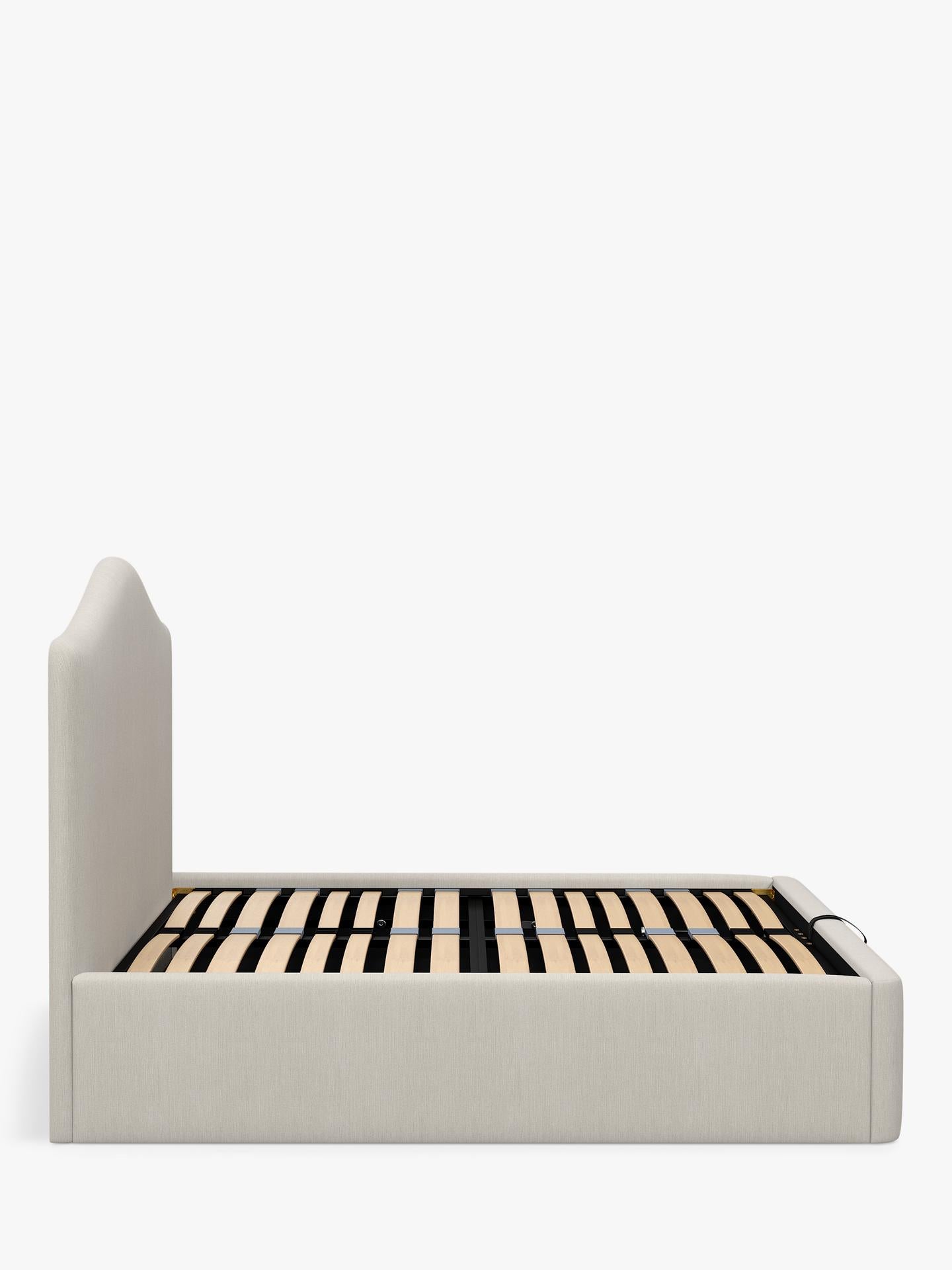 A super king size John Lewis Alice ottoman bed frame in beige cotton-effect fabric, featuring a tall button-tufted headboard and a gas-lift base opened to show the large under-bed storage area.