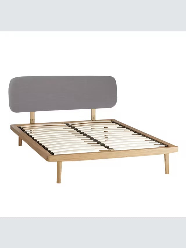 A modern bedroom setup featuring the John Lewis Bow king-size oak bed frame with an upholstered headboard, styled with neutral bedding