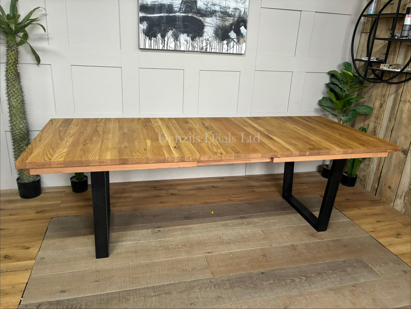 John Lewis Calia 8-10 Seater Extending Dining Table in natural solid oak with a rustic slatted wood top and a black welded iron base