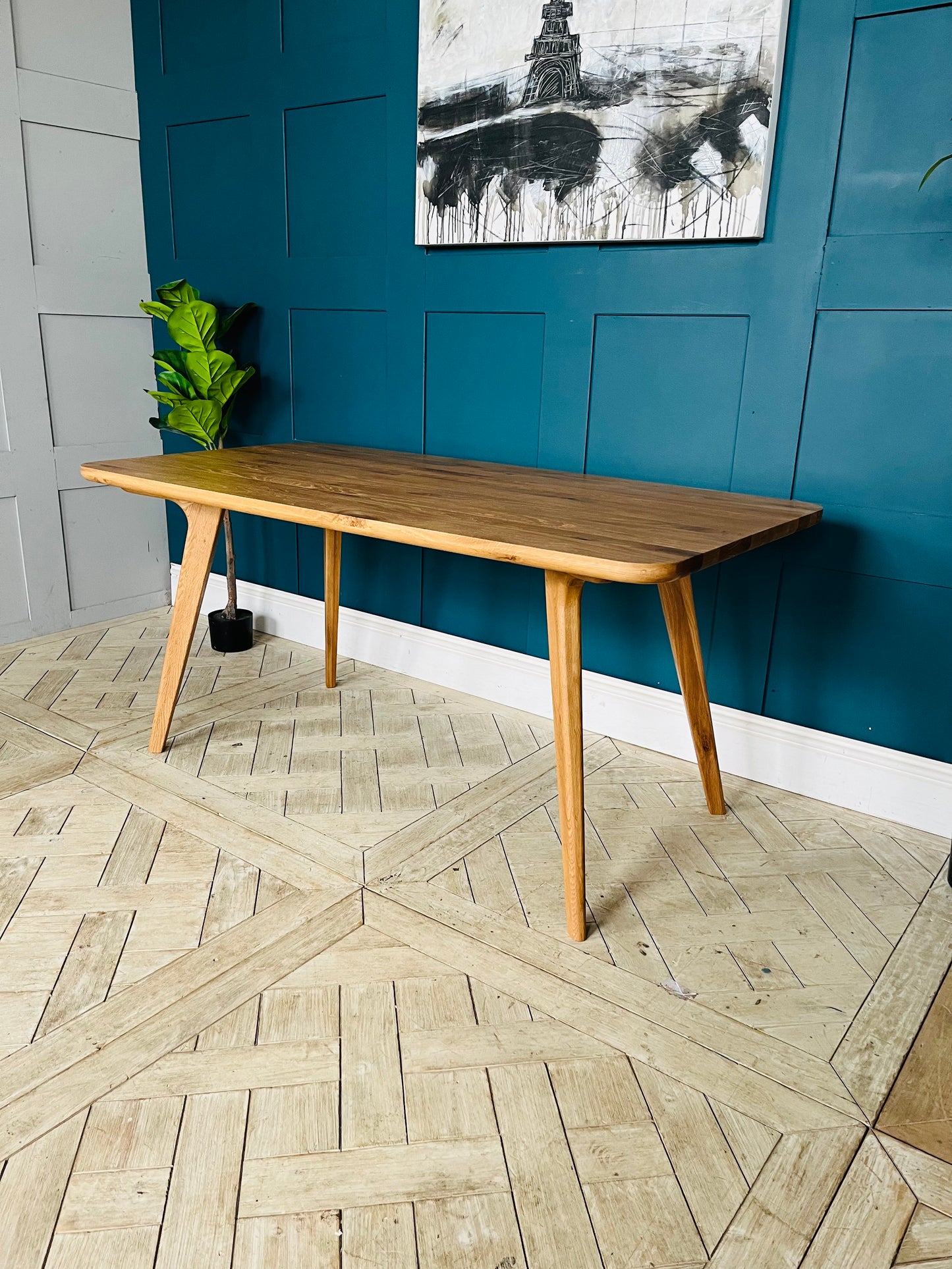 John Lewis Cara 4-seater dining table in natural American oak with slender legs and a slim-line top