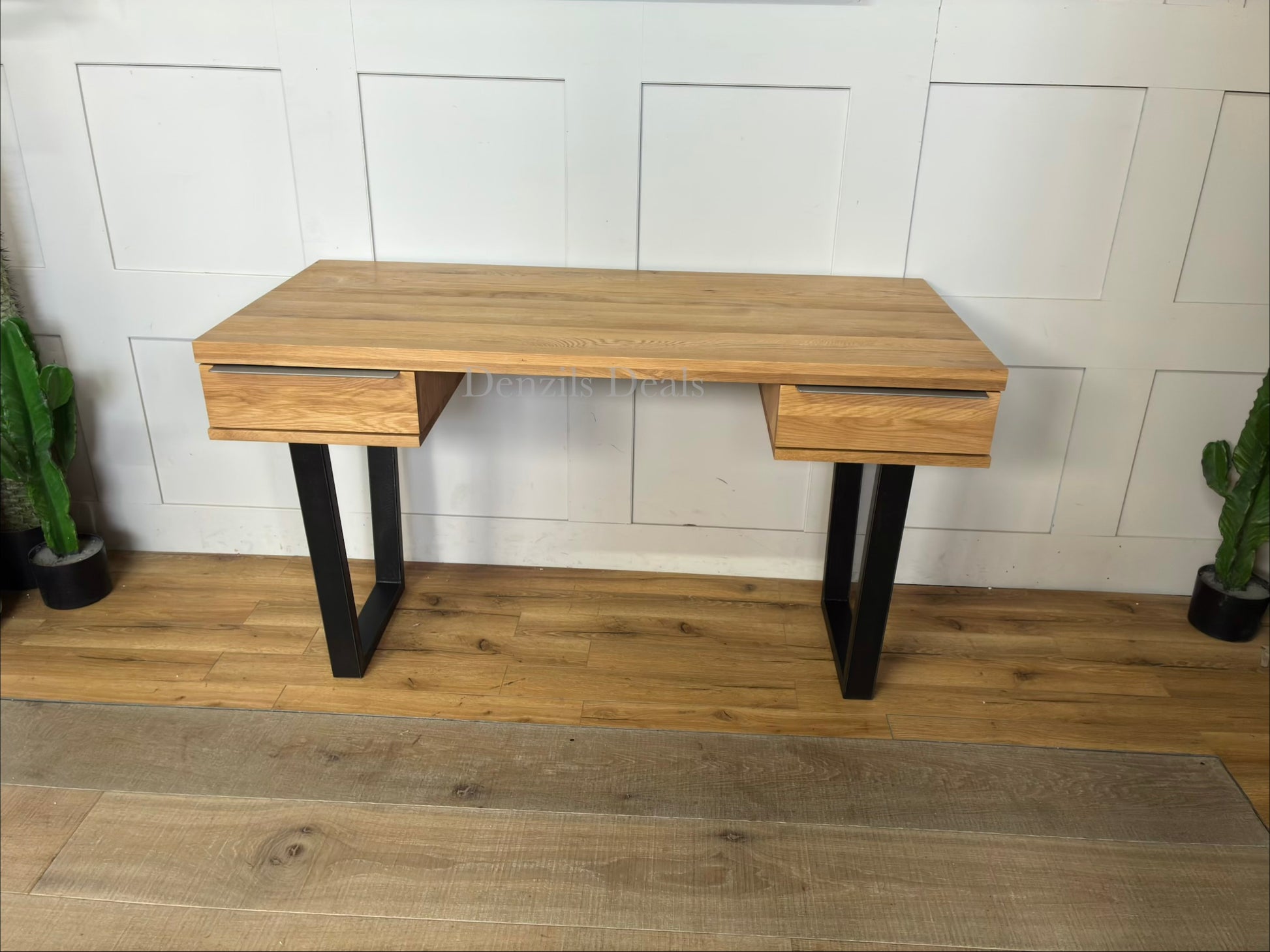 Compact home office desk made from solid oak with a wire-brushed, distressed finish. It features two sliding drawers with slim iron handles and sits on a minimalist, square-shaped black iron frame