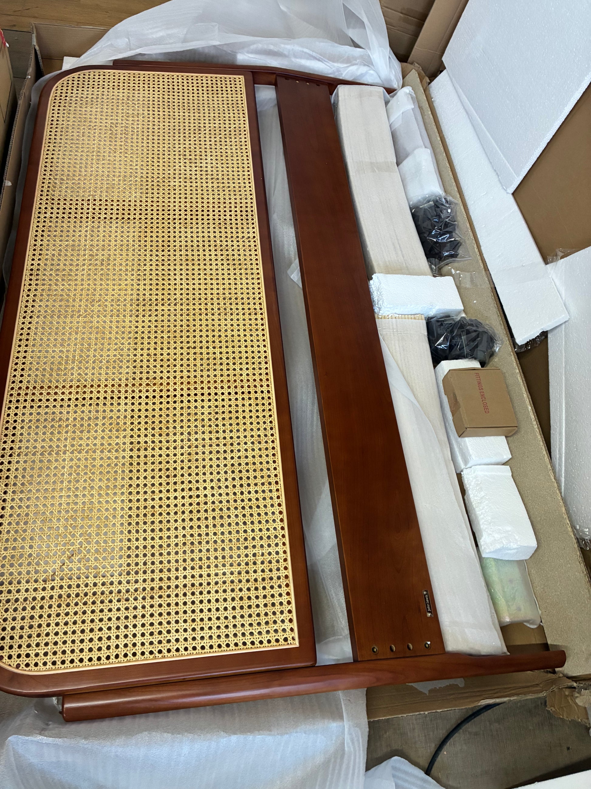 John Lewis King Size Rattan Bed Frame in a warm cherry wood finish with a curved cane headboard.