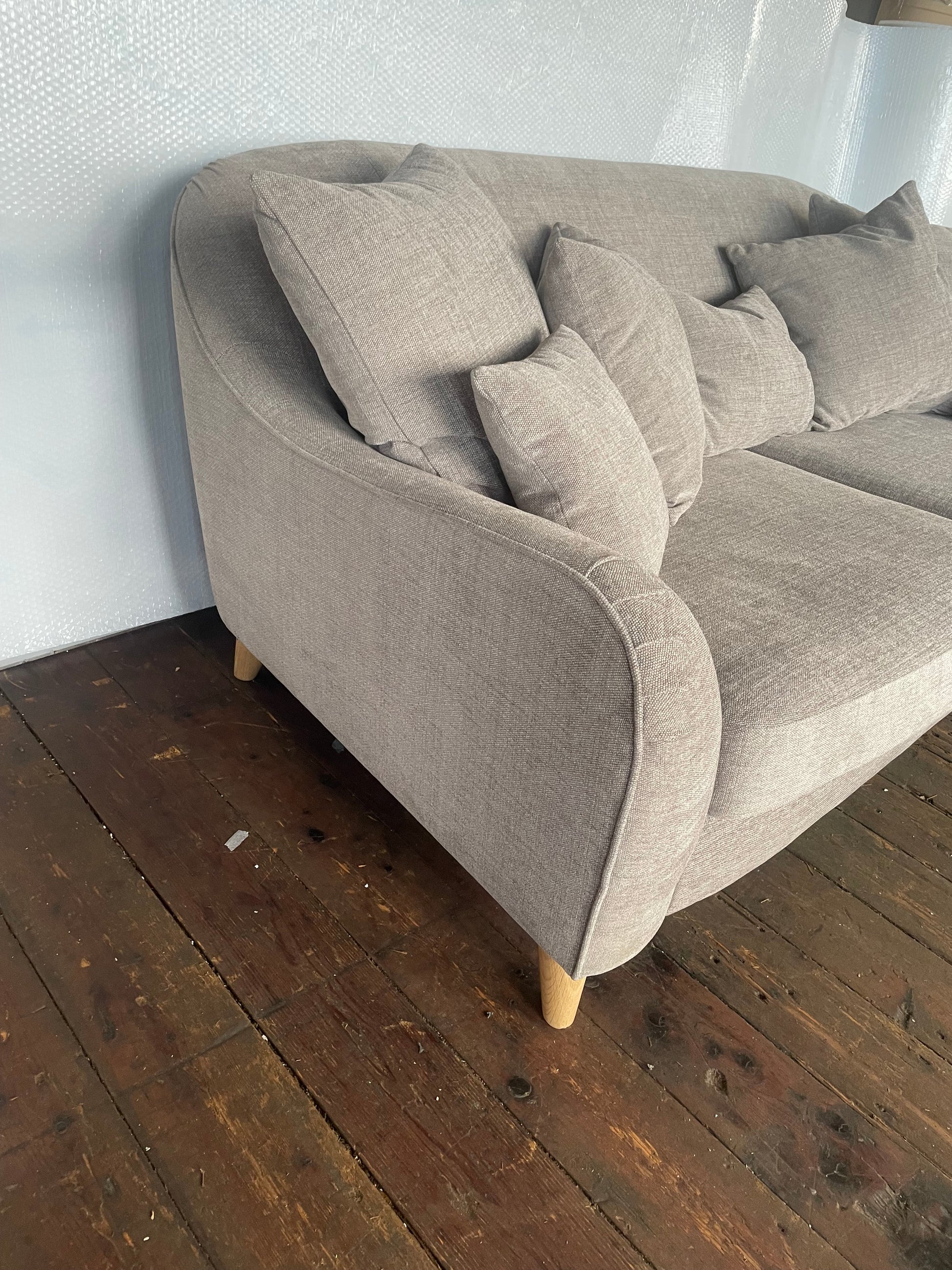 The John Lewis Laze medium 3-seater sofa in Opal Putty, styled in a bright, modern living room with coordinating neutral scatter cushions