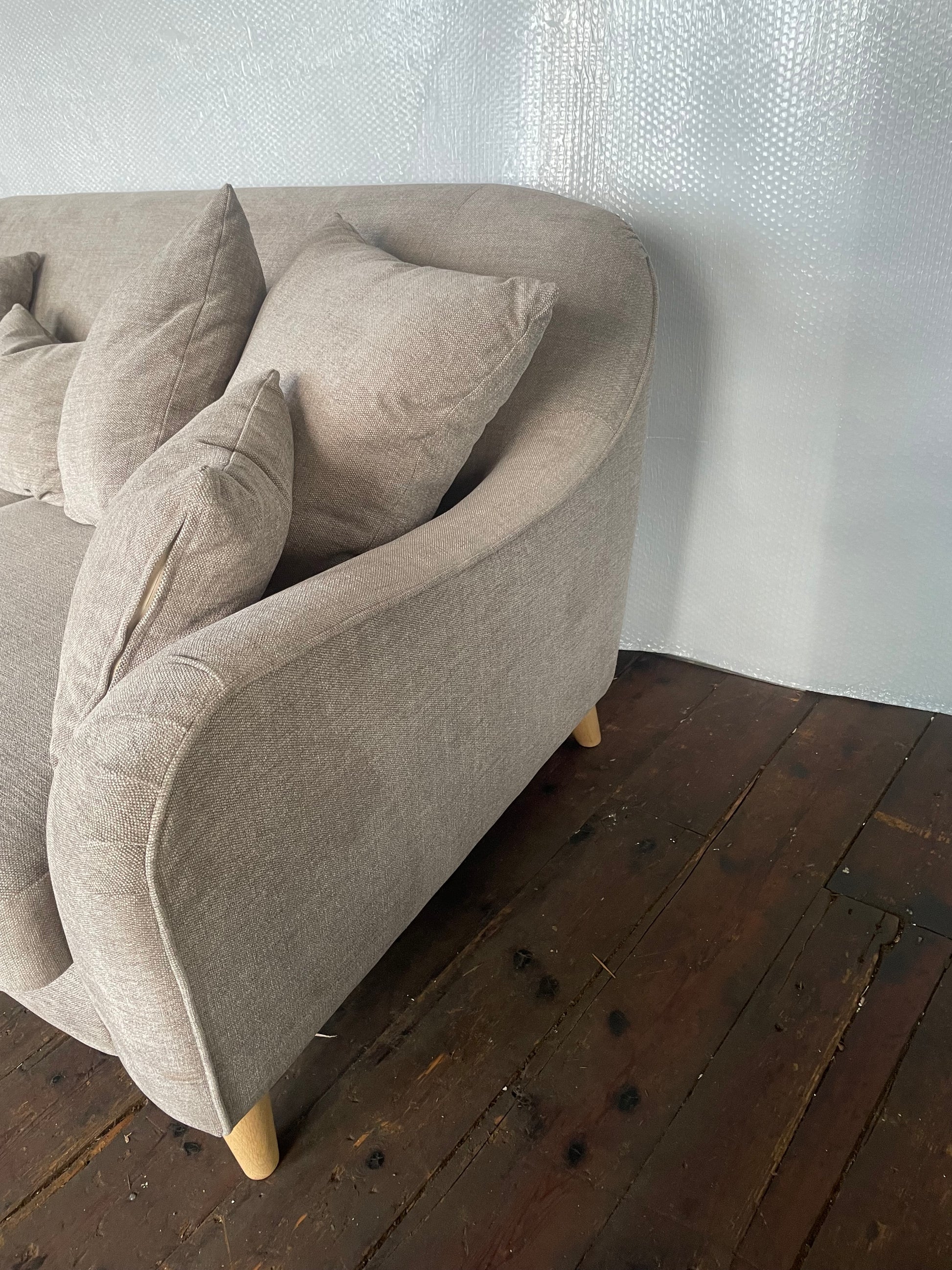 The John Lewis Laze medium 3-seater sofa in Opal Putty, styled in a bright, modern living room with coordinating neutral scatter cushions