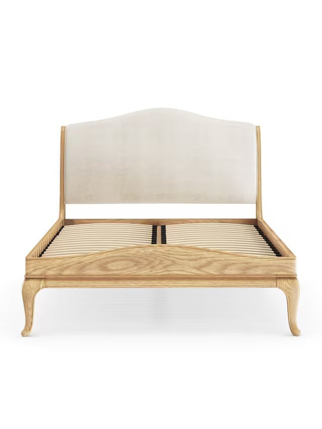 John Lewis Louis Low End Sleigh Bed Frame, Super King Size, Oak  wooden sleigh bed frame crafted from solid oak with a warm, natural lacquered grain. The bed features a tall, gently scrolled headboard with traditional French-style carvings and a matching low-end footboard that curves subtly outward