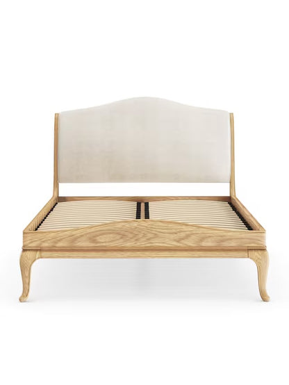 John Lewis Louis Low End Sleigh Bed Frame, Super King Size, Oak  wooden sleigh bed frame crafted from solid oak with a warm, natural lacquered grain. The bed features a tall, gently scrolled headboard with traditional French-style carvings and a matching low-end footboard that curves subtly outward