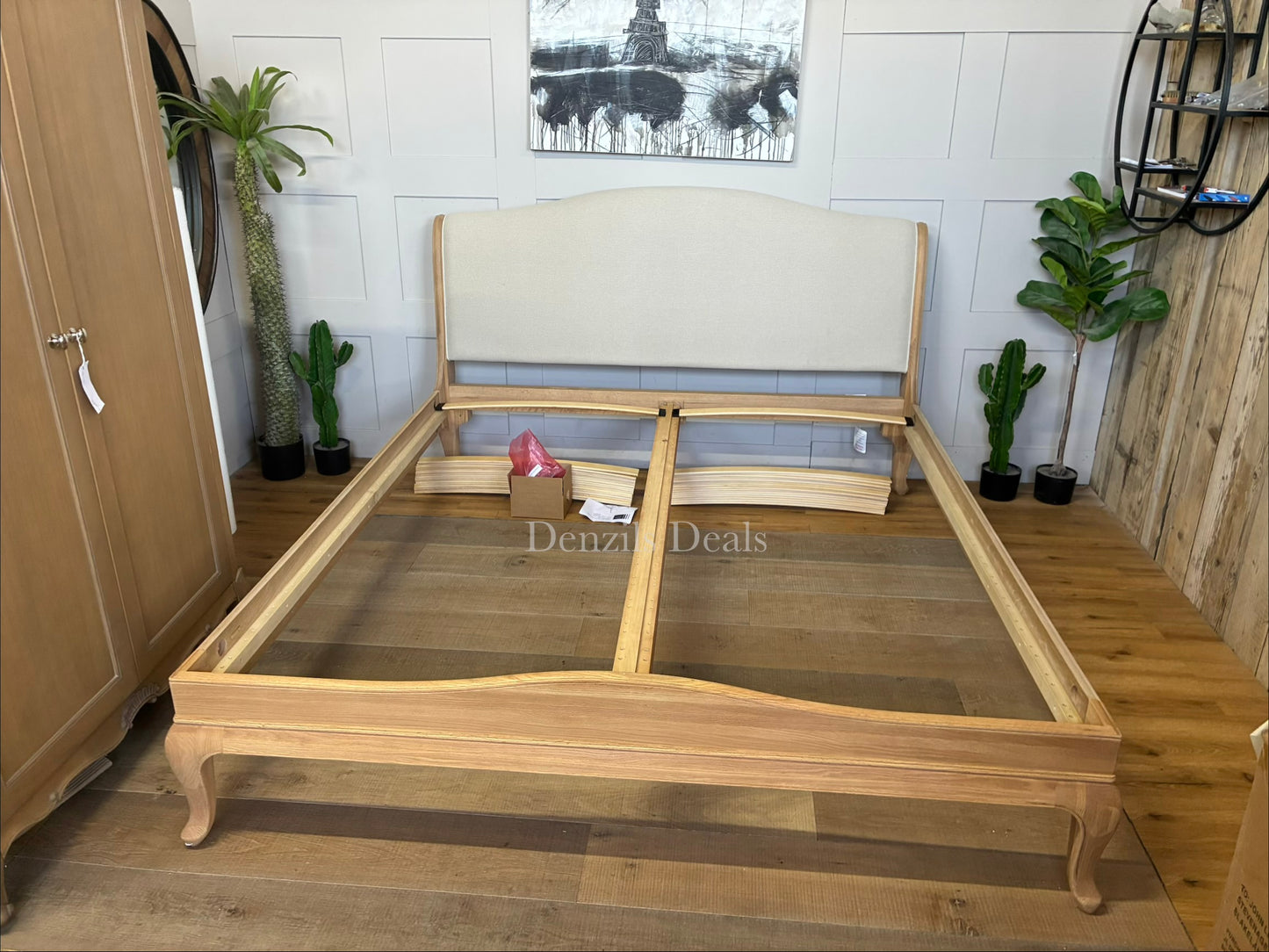 A high-quality John Lewis Louis oak sleigh bed frame in a super king size, featuring a classic curved headboard and footboard with a smooth, natural honey-toned wood grain finish.
