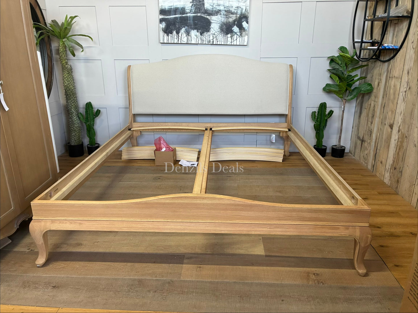 A high-quality John Lewis Louis oak sleigh bed frame in a super king size, featuring a classic curved headboard and footboard with a smooth, natural honey-toned wood grain finish.