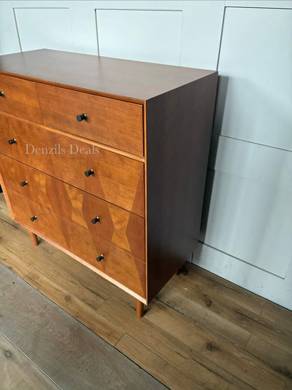 John Lewis Marquetry chest of drawers placed in a bright, calming bedroom setting beside a modern bed