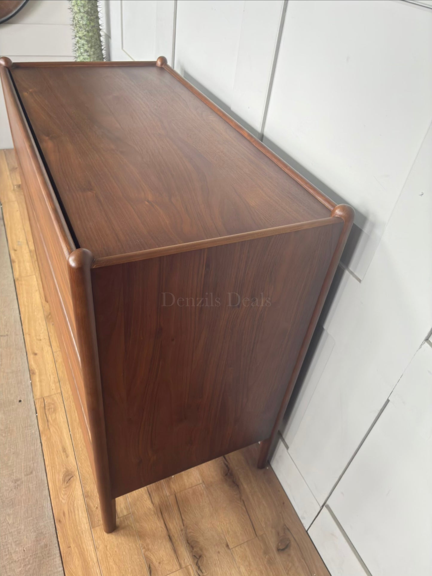 Top and side Minimalist mid-century modern 3-drawer dresser by John Lewis, crafted from wood with a warm walnut stain, tray-edge top, and sleek handle-less design."