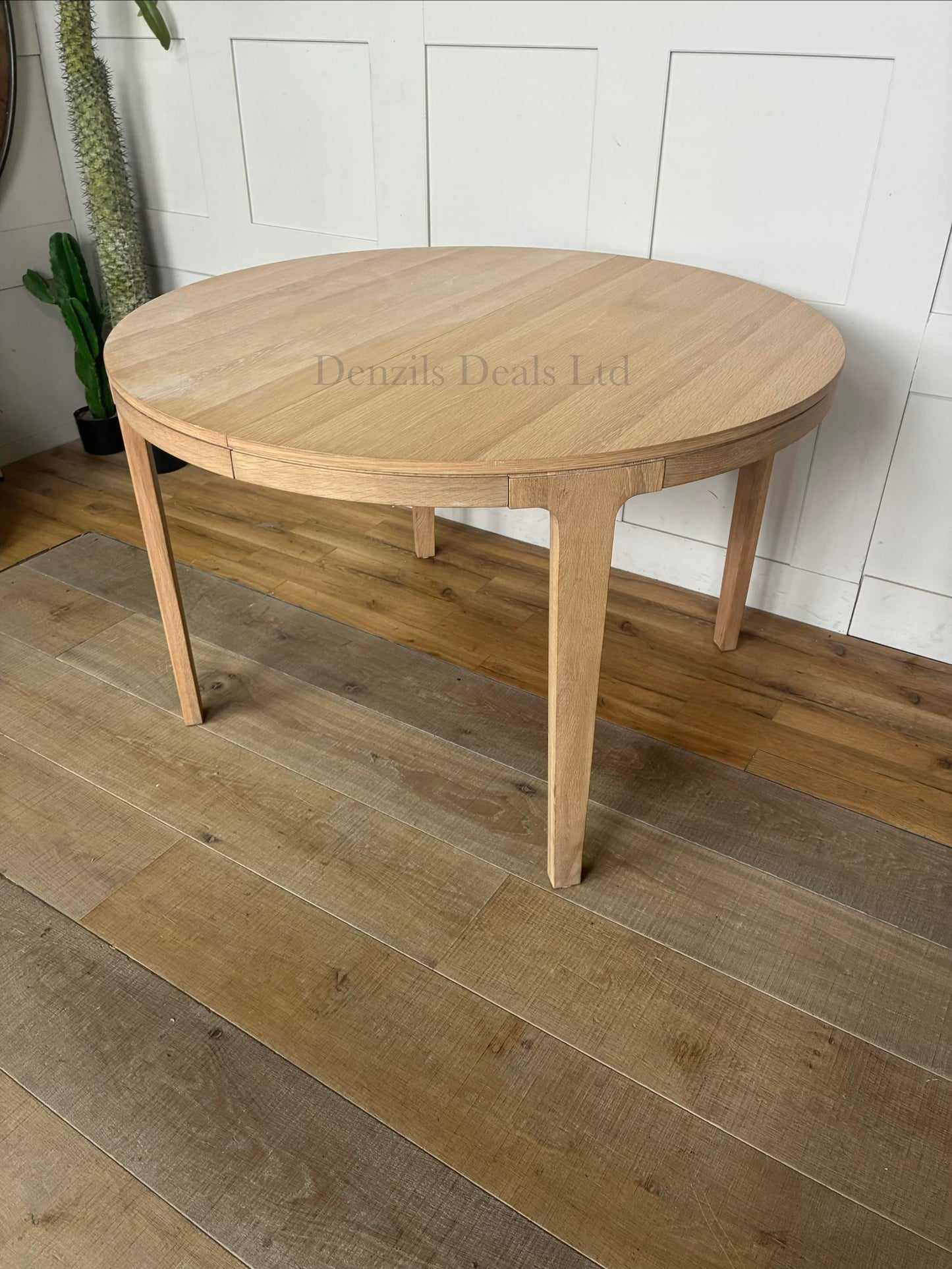 John Lewis Mira II extendable round dining table in light natural oak wood with a Scandi design.