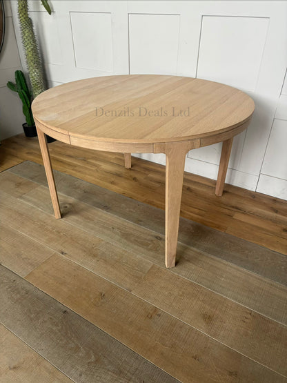 John Lewis Mira II extendable round dining table in light natural oak wood with a Scandi design.