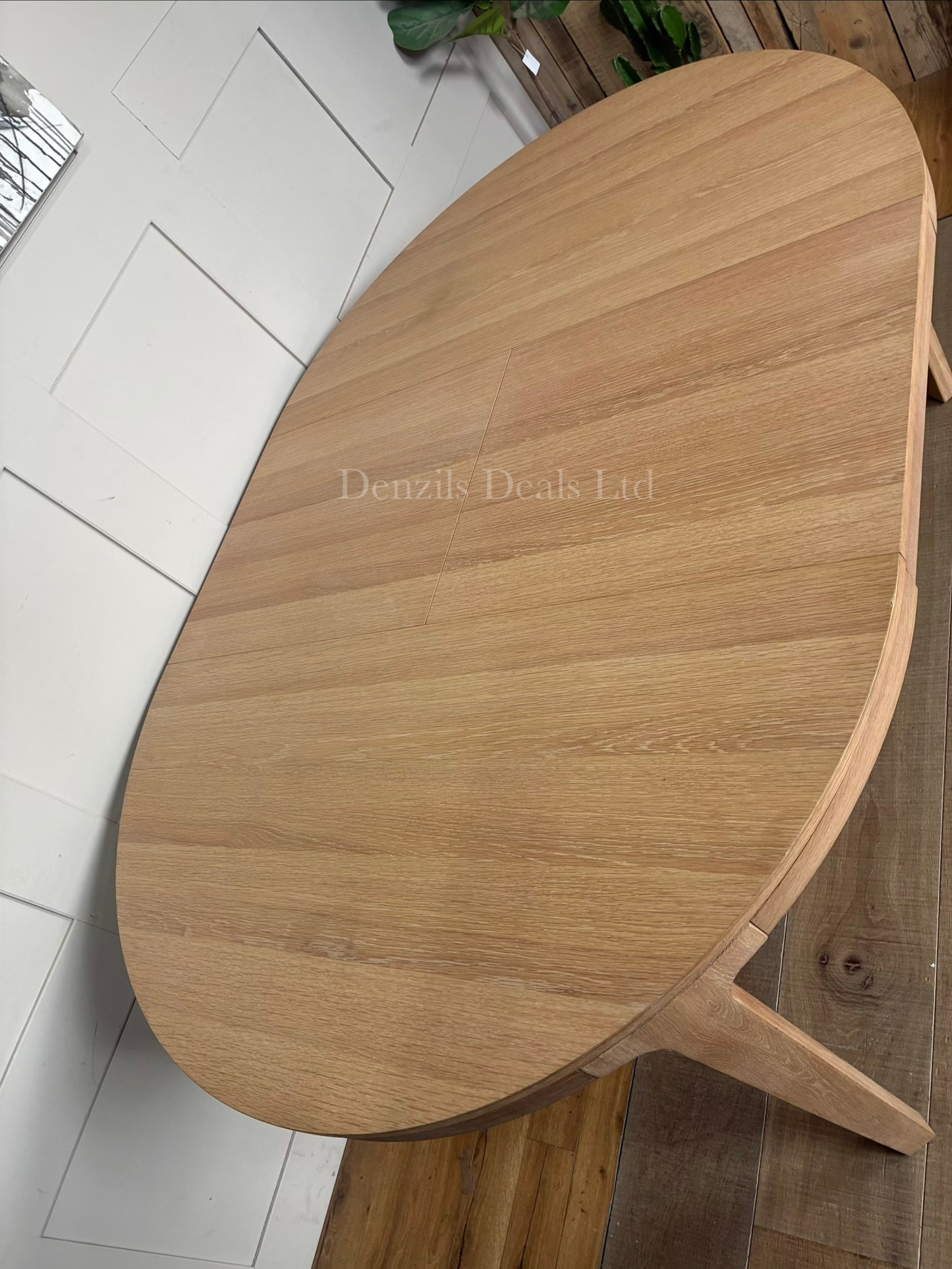 John Lewis Mira II extending round dining table made from solid oak and oak veneers.
