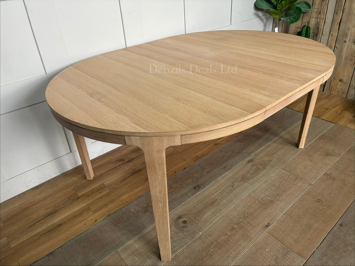 John Lewis Mira II extending round dining table made from solid oak and oak veneers.