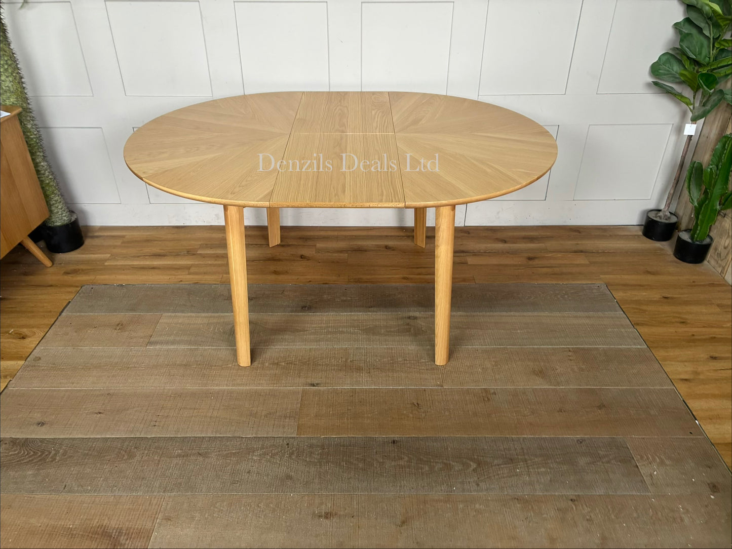 John Lewis Notch round oak extending dining table with a natural wood grain starburst veneer top