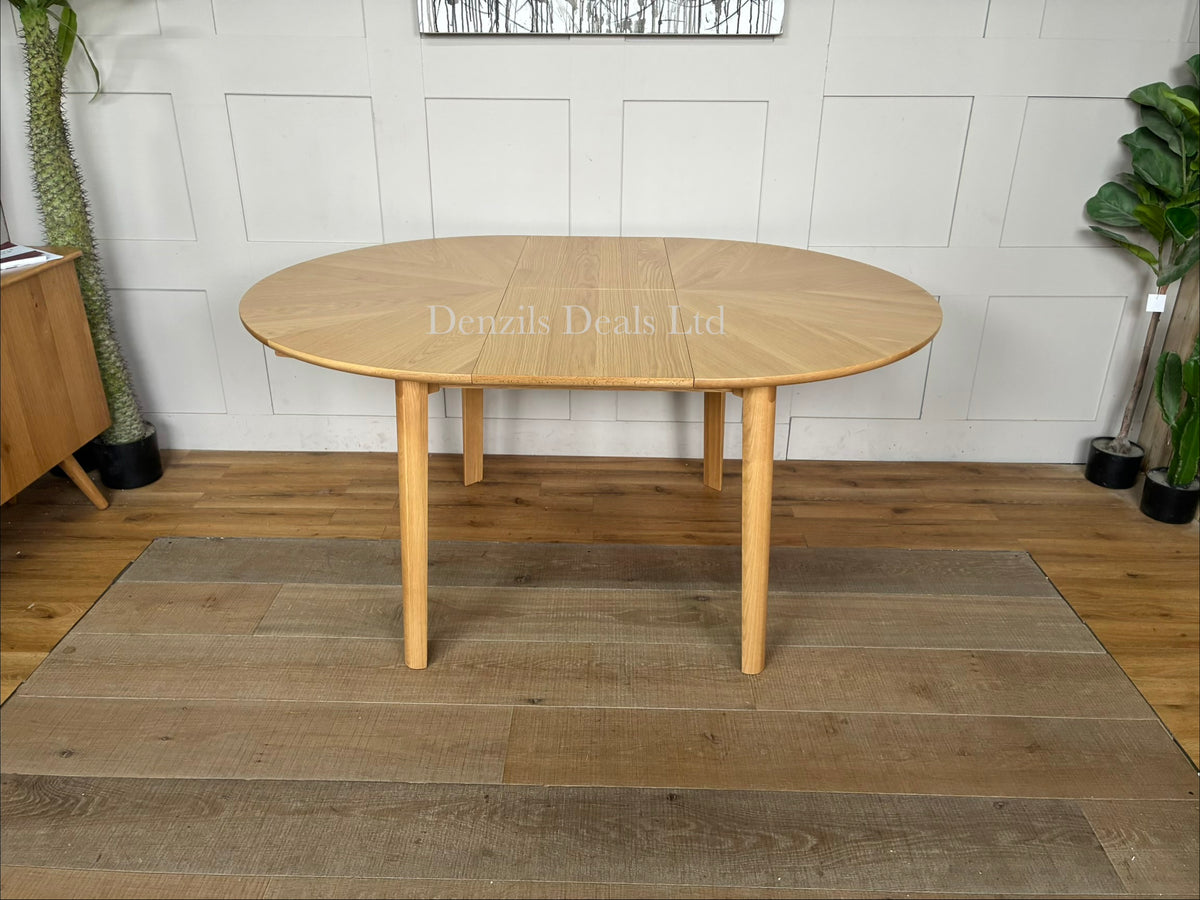 John Lewis Notch round oak extending dining table with a natural wood grain starburst veneer top