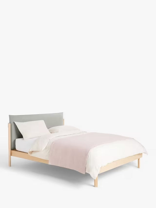 John Lewis Pillow double bed frame in solid oak with a grey cushioned headboard.