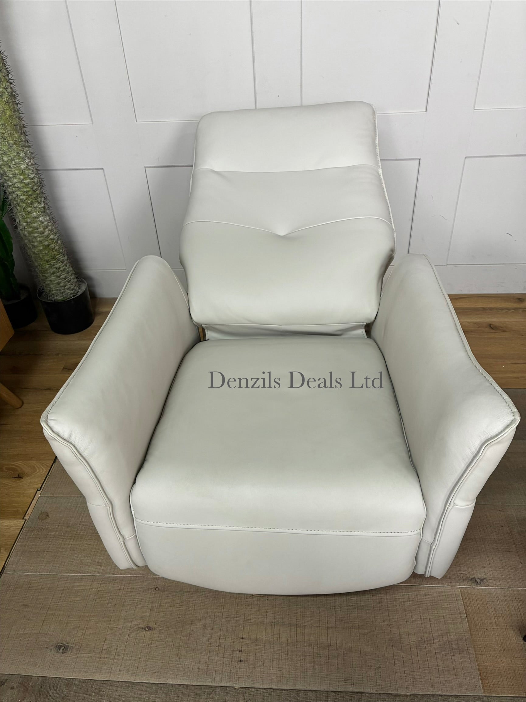 Minimalist modern interior scene featuring a John Lewis Relaxed premium leather recliner chair and footstool. The sleek, tan-coloured leather upholstery contrasts with thin metal legs, offering a refined look for a modern living space.