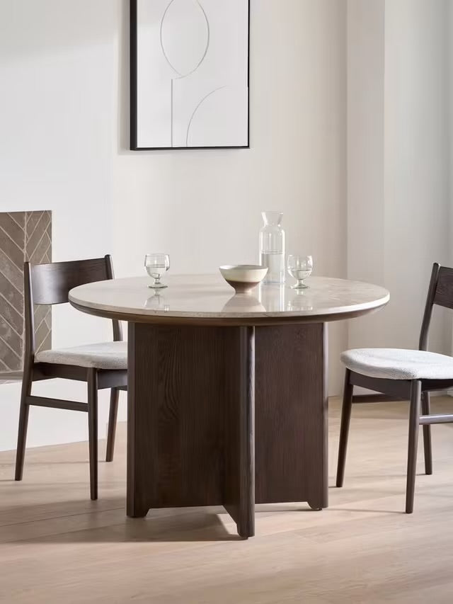 John Lewis Ritz round marble dining table in brown with a thick wooden pedestal base.