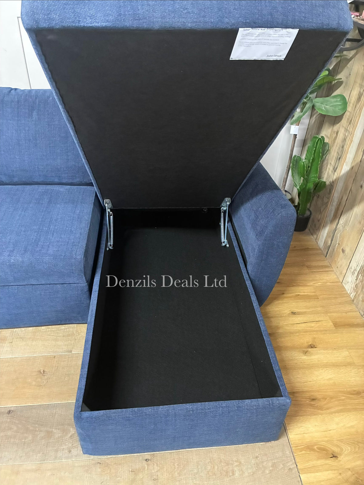 The John Lewis Sansa sofa bed, showing hidden storage and fully extended into a large double bed, showing the main section pulled out alongside the stationary chaise section to form a wide, flat foam mattress sleeping area.