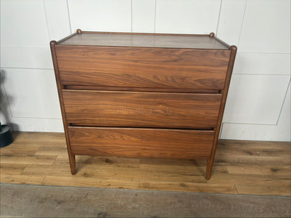 John Lewis Scandi 3-drawer wood chest in a walnut finish with tapered legs and handle-less drawers."