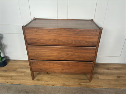 John Lewis Scandi 3-drawer wood chest in a walnut finish with tapered legs and handle-less drawers."