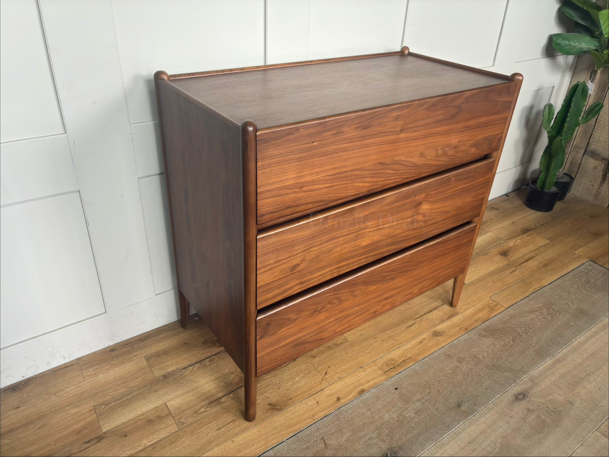 John Lewis Scandi 3-drawer wood chest in a walnut finish with tapered legs and handle-less drawers."