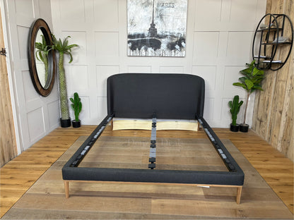 John Lewis Show-Wood King Size Bed Frame upholstered in dark gray brushed tweed charcoal fabric, featuring a curved headboard and natural wood trim base