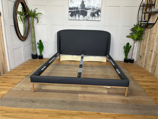 John Lewis Show-Wood King Size Bed Frame upholstered in dark gray brushed tweed charcoal fabric, featuring a curved headboard and natural wood trim base
