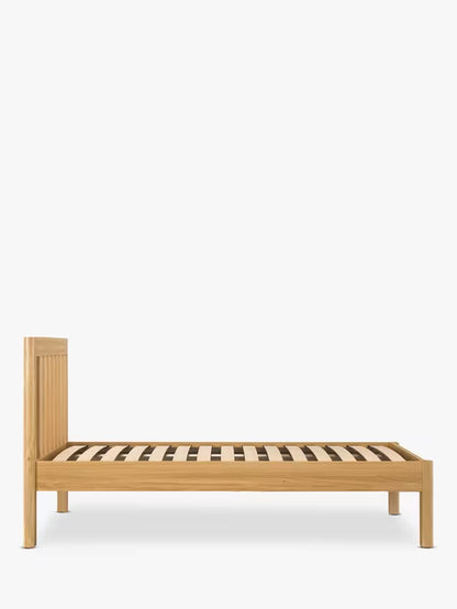 John Lewis Spindle Bed Frame, single, in Natural Oak with slatted headboard and rounded edges."