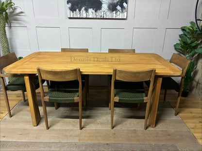 John Lewis Terra rectangular garden dining table with a weather-resistant teak wood frame and gently curved edges, set outdoors on a wooden deck