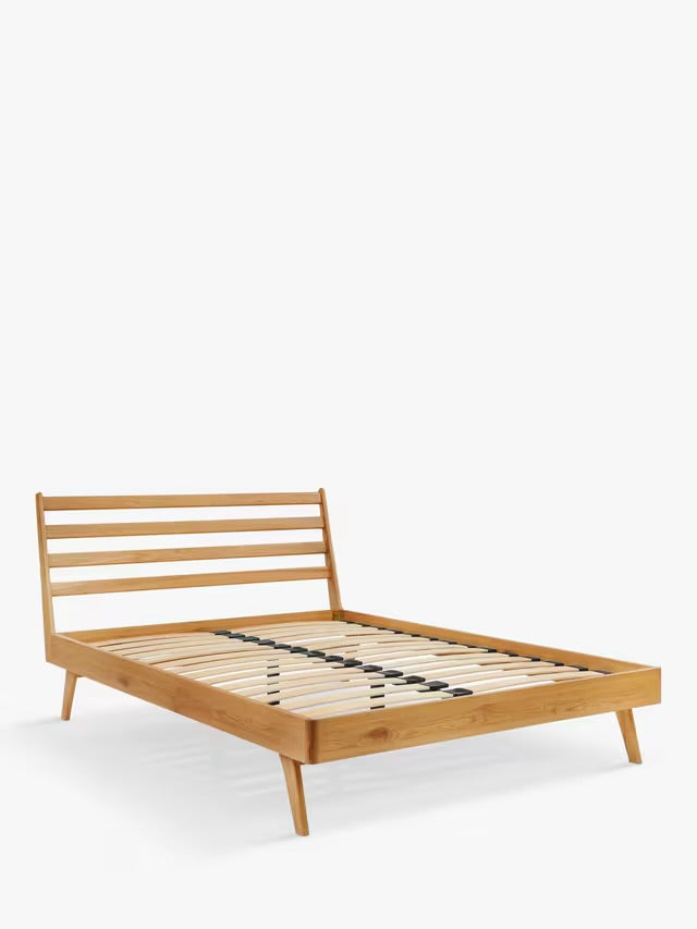 John Lewis X-Ray king size oak wood bed frame featuring a slatted wooden headboard and tapered legs.