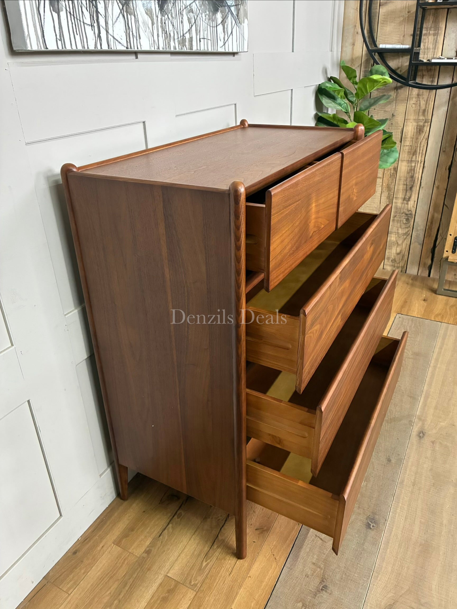 John Lewis Scandi 5 Drawer Wood Chest, Walnut Finish with five storage drawers and the top surface has a slight tray-edge design so your bedside essentials stay secure. Rounded posts, tapered legs and sleek, handle-less drawers all honour Scandinavian design principles, so it's perfect for keeping your bedroom a calm, uncluttered and simple space.