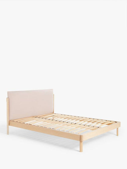 A John Lewis contemporary double bed with a natural wood frame and grey cushioned headboard, styled in a minimalist modern bedroom with white bedding.