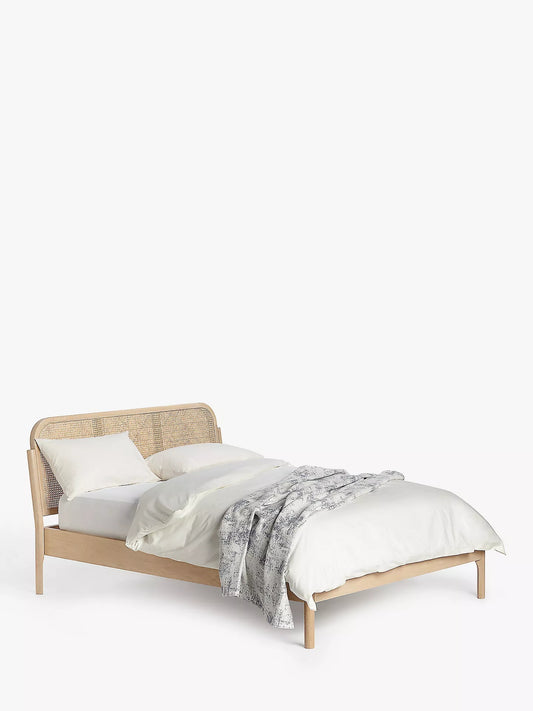 John Lewis king size bed frame in natural oak with a curved, airy cane rattan headboard and solid slatted base.