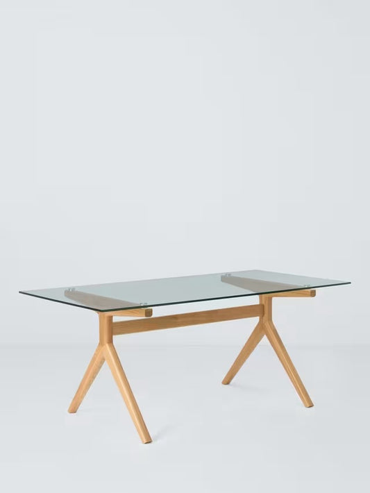 John Lewis Poise Rectangular Glass Top Dining Table. A rectangular dining table featuring a clear, toughened glass top supported by a minimalist solid oak frame with a light-coloured lacquer finish and soft, rounded edges