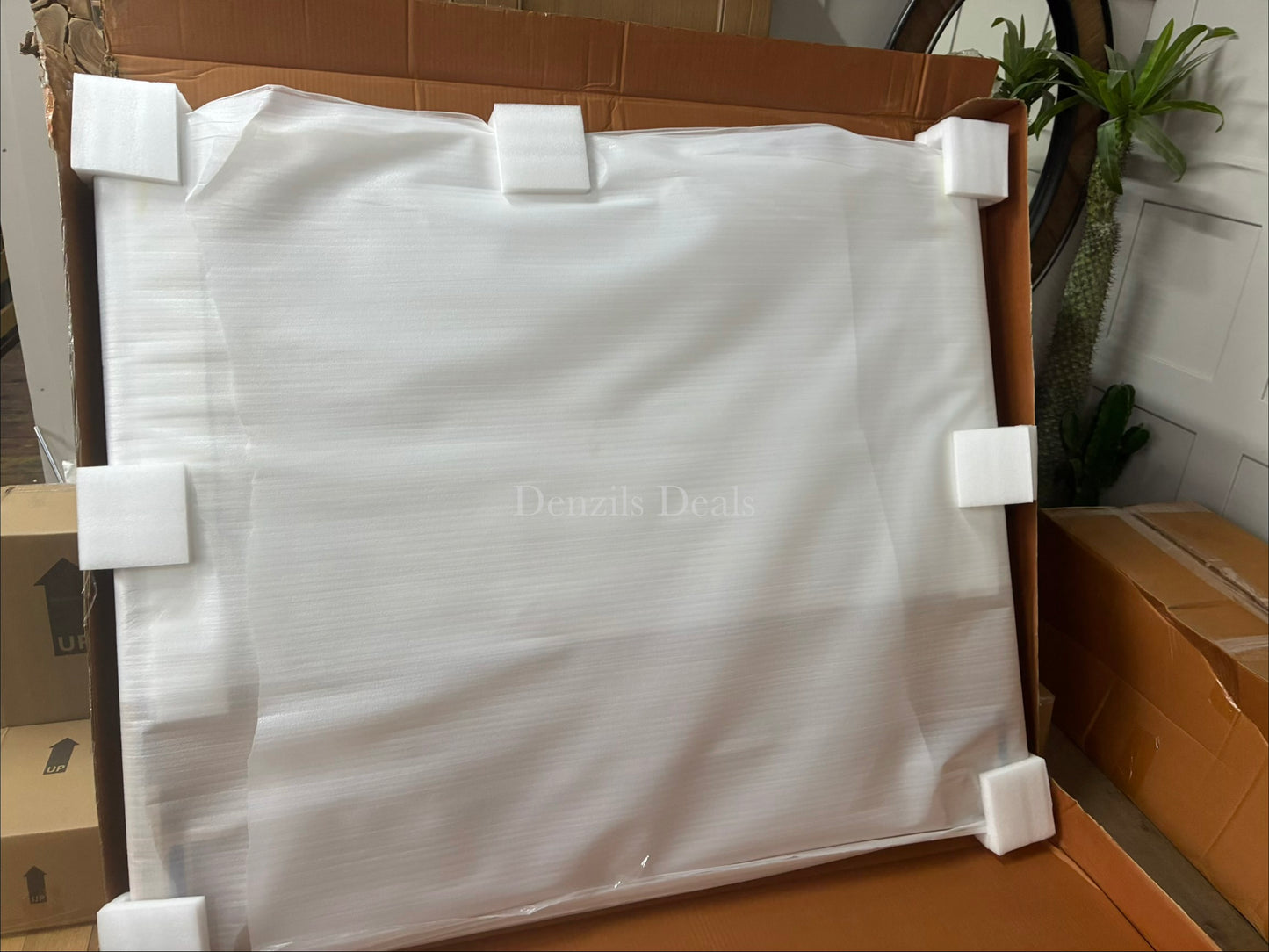 A minimalist bedroom setting featuring a natural wood storage bed frame with a padded headboard and four integrated under-bed drawers