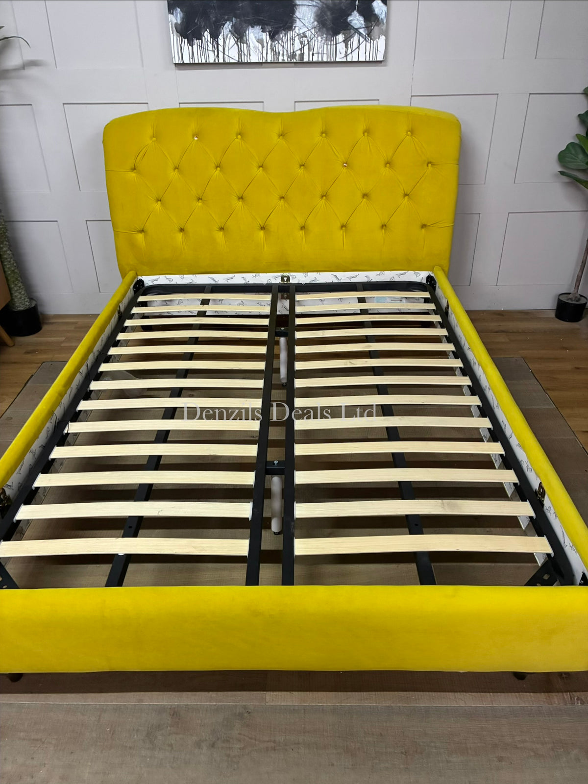 Joules Windsor king-size bed frame in mustard yellow velvet from DFS, featuring a button-backed Chesterfield headboard and turned wooden legs.